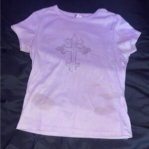 A white T-shirt with a rhinestone cross on the front.